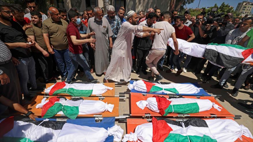 Una multitud se reúne alrededor de cuerpos de palestinos que murieron tras un ataque israelí en Gaza, 15 de mayo de 2021. (Foto: AFP)