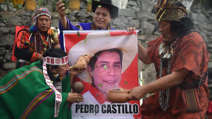 Los chamanes sostienen un cartel del candidato presidencial Pedro Castillo en Lima el 26 de mayo de 2021. (Foto: AFP)