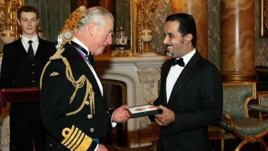 El Príncipe Carlos entrega el título de caballero al empresario saudí Mahfouz Marei Mubarak bin Mahfouz en el Palacio de Buckingham en 2016.