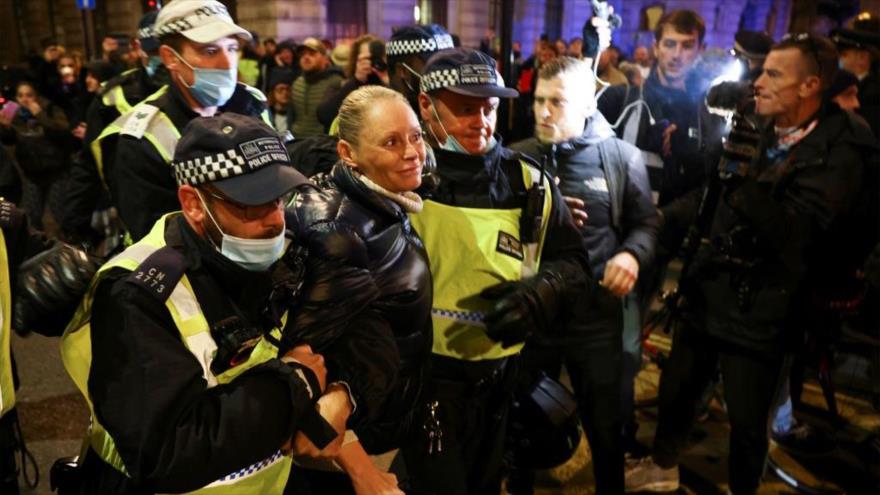 Una mujer es detenida por oficiales de policía en una protesta en Londres, 5 de noviembre de 2020. (Foto: Reuters)