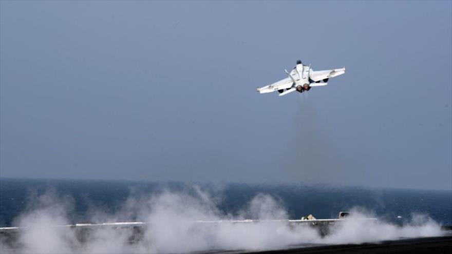 Caza F-18 de la ‘coalición anti-EIIL’ liderada por EE.UU. despega desde el portaviones USS Dwight D. Eisenhower para lanzar ataques en Siria.
