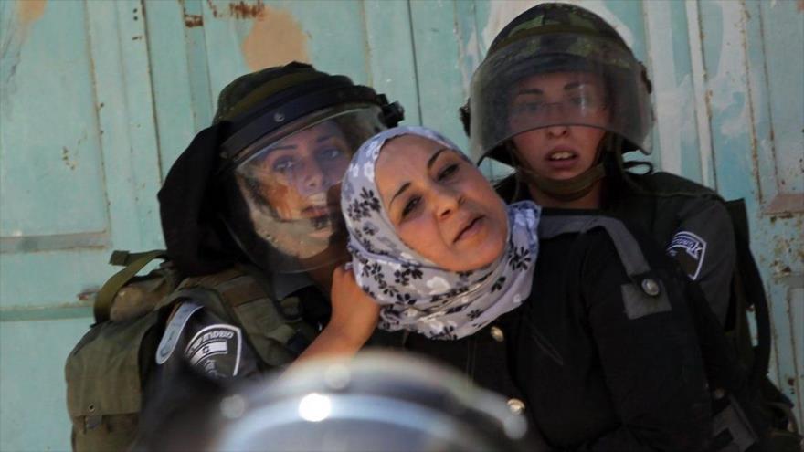 Fuerzas israelíes detienen a una mujer palestina.