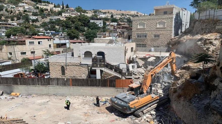 Una excavadora israelí está demoliendo una casa palestina en el barrio de Silwan, en el este de la ciudad ocupada de Al-Quds (Jerusalén).
