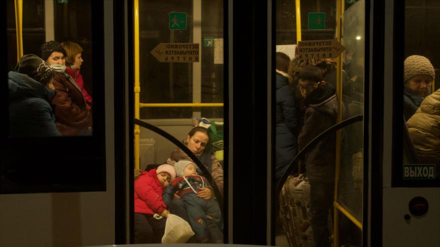 Las personas evacuadas de la República Popular de Donetsk se sienten en un autobús para evacuar hacia Rusia, 20 de febrero de 2022. (Foto: AFP)