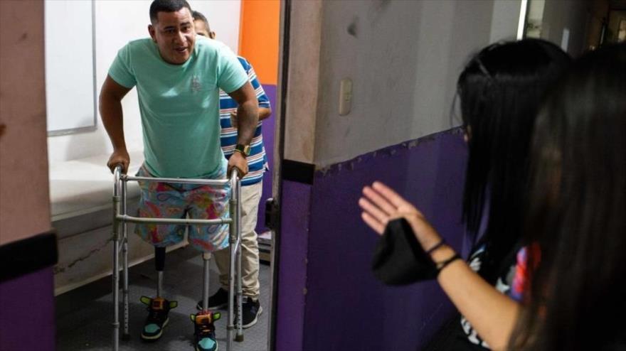 Un discapacitado utiliza piernas ortopédicas para caminar en un taller de prótesis en Caracas, capital venezolana, 11 de febrero de 2022.