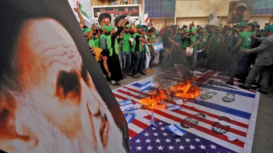 Los iraquíes queman las banderas de Israel en la ciudad de Nayaf, durante las marchas del Día Mundial de Al-Quds, 7 de mayo de 2021.