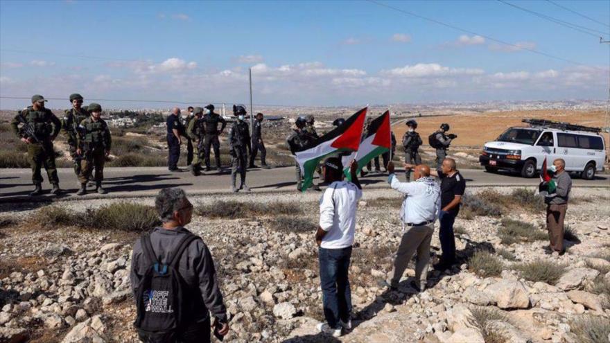 Manifestantes portan banderas de Palestina en una protesta contra los asentamientos israelíes en Masafer Yatta, la Cisjordania ocupada, 23 de octubre de 2021. (Foto: Reuters)