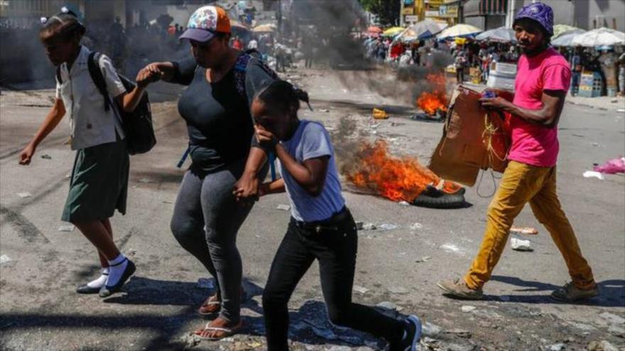 La gente intenta huir debido a tiroteos entre bandas armadas, en Puerto Príncipe, Haití.