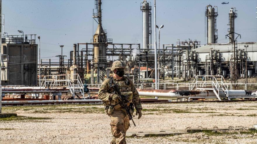 Un soldado estadounidense camina en los campos petroleros en la provincia siria de Al-Hasaka, 13 de febrero de 2021. (Foto: AFP)