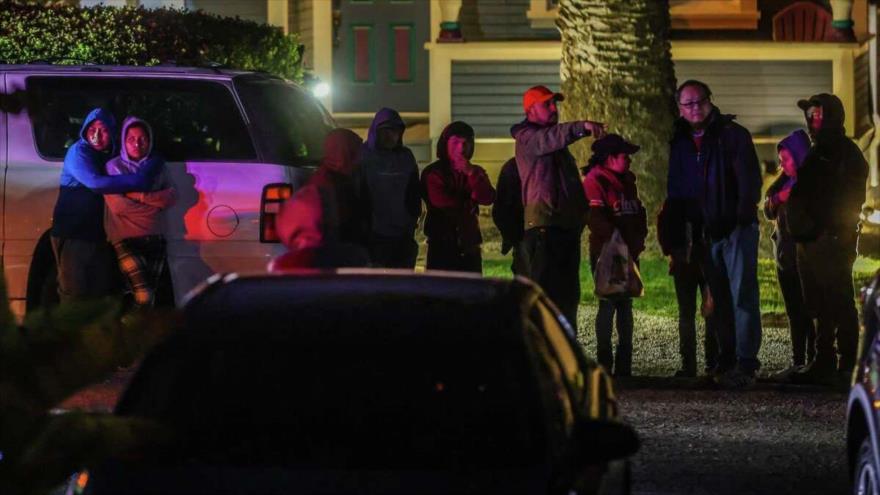 La gente se abraza en la escena de un tiroteo mortal donde ocurrieron varias muertes en la autopista 92 en Half Moon Bay, California, 23 de enero de 2023.