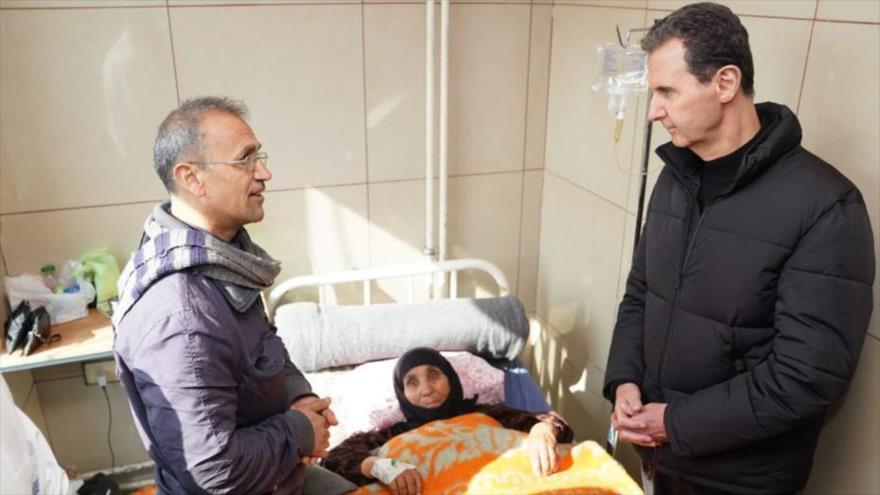 El presidente sirio, Bashar al-Asad (dcha.), visita algunos supervivientes de los terremotos en el hospital de Alepo, 10 de febrero de 2023. (Foto: SANA)