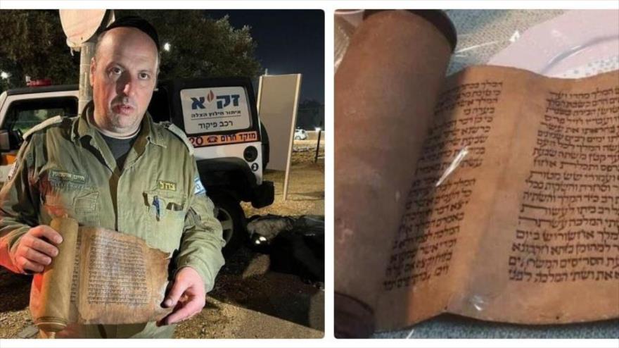 Un miembro del equipo de rescate israelí sostiene el libro histórico de Ester recuperado de la sinagoga de Antioquía, Turquía.