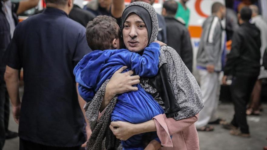 Una madre palestina y su hijo huyen durante el ataque israelí al hospital de Al-Shafa, 21 de marzo de 2024. (Foto: ABC News)