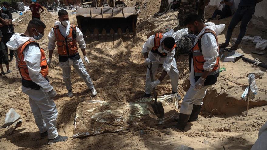 Trabajadores desentierran cadáveres encontrados en el Hospital Al-Naser en Gaza, 23 de abril de 2024.