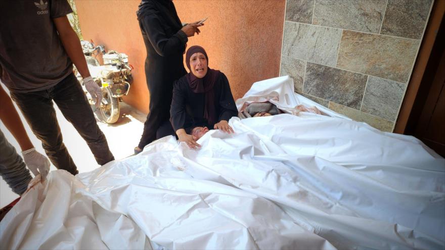 Una mujer palestina llora junto a los cuerpos sin vida de sus familiares asesinados en un ataque israelí en Jan Yunis, 13 de julio de 2024.