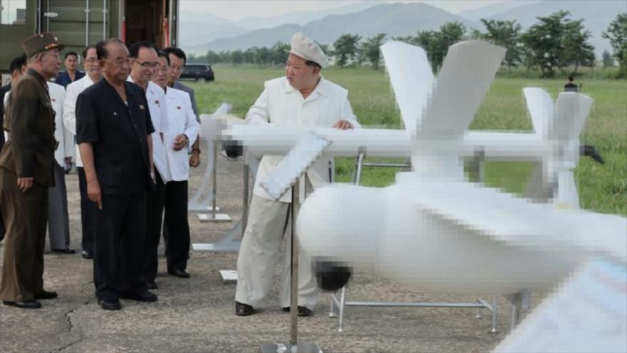 La foto, publicada, el 26 de agosto de 2024, por la KCNA, muestra al líder norcoreano, Kim Jong-un (primero por la dcha.), inspeccionado unos drones, durante una prueba de desempeño, el 24 de agosto de 2024.
