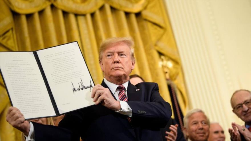 El presidente de EE.UU., Donald Trump, muestra una orden ejecutiva sobre el antisemitismo durante una ceremonia en Casa Blanca,11 de diciembre de 2019.