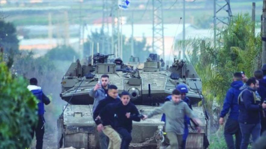 Los niños palestinos corren ante el tanque israelí en Cisjordania, 24 de febrero de 2025.