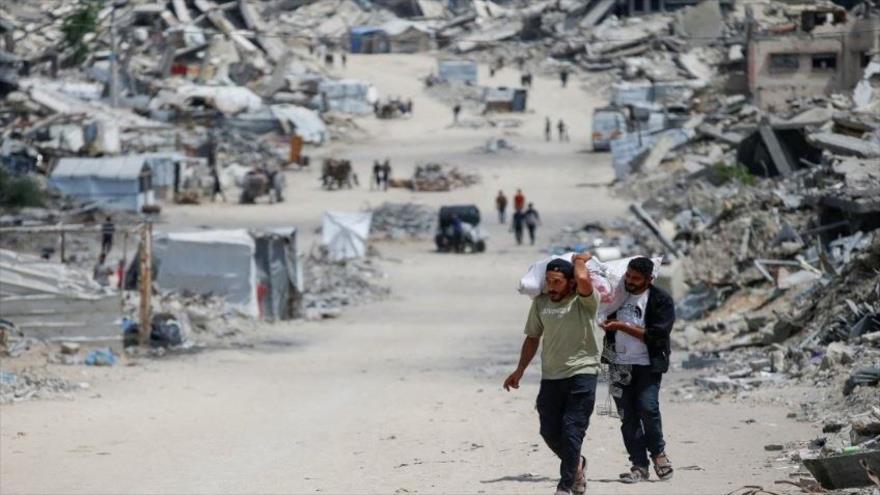 Palestinos se abren camino con sus pertenencias mientras huyen de sus hogares después de que el ejército israelí emitiera órdenes de evacuación del norte de la Franja de Gaza, 22 de mayo de 2025.