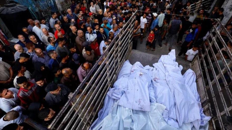 Palestinos rodean los cuerpos de los miembros de la familia Abu Dalal, asesinados en los ataques israelíes contra su hogar en Nuseirat, Gaza, 29 de octubre de 2025. (Foto: Reuters)